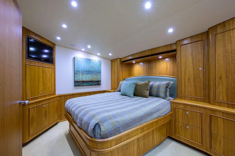 Slide: The Image of Luxurious bedroom in 2011 Paul Mann Custom 81 Convertible yacht with wood paneling and cozy bedding. - 24