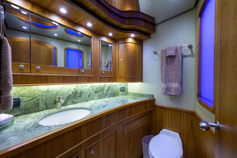 Slide: The Image of Luxurious bathroom in 2011 Paul Mann Custom 81 Convertible yacht with wood cabinetry and marble countertop. - 27