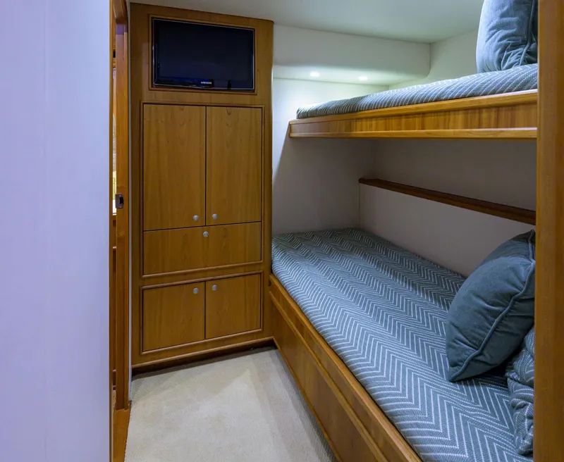 Slide: The Image of Interior of 2011 Paul Mann Custom 81 Convertible with bunk beds and wooden cabinetry. - 30