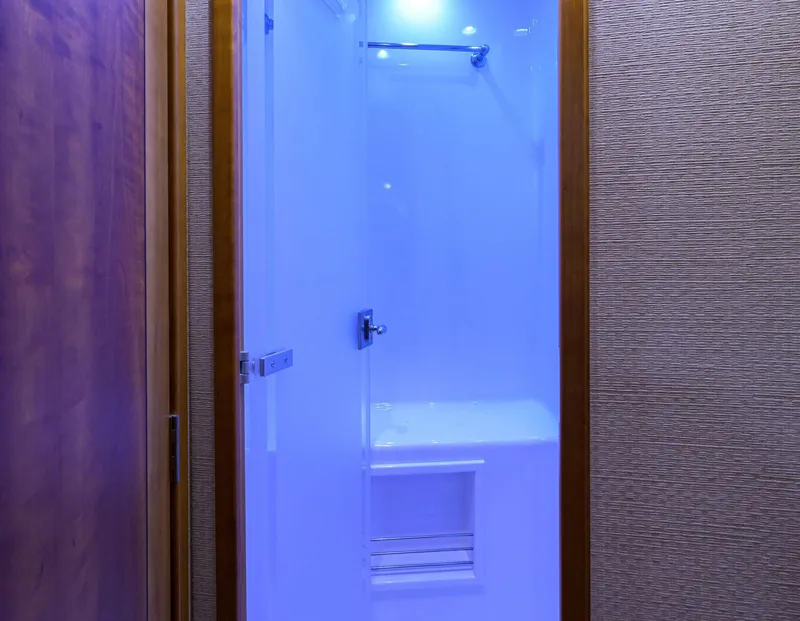 Slide: The Image of Shower area in 2011 Paul Mann Custom 81 Convertible yacht with blue lighting. - 34