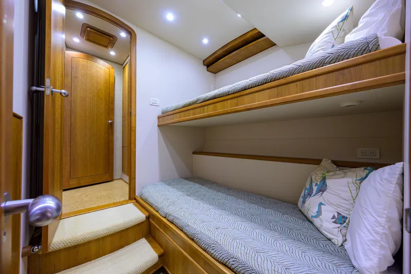 Slide: The Image of Interior of 2011 Paul Mann Custom 81 Convertible with cozy bunk beds and wooden finish. - 36
