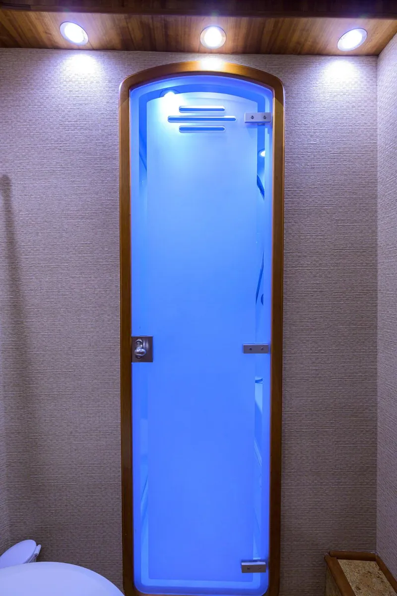 Slide: The Image of Illuminated blue frosted glass door in 2011 Paul Mann Custom 81 Convertible yacht interior. - 39