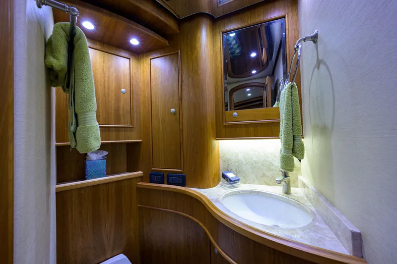 Slide: The Image of Luxurious bathroom in 2011 Paul Mann Custom 81 Convertible yacht with wood cabinetry and modern fixtures. - 43