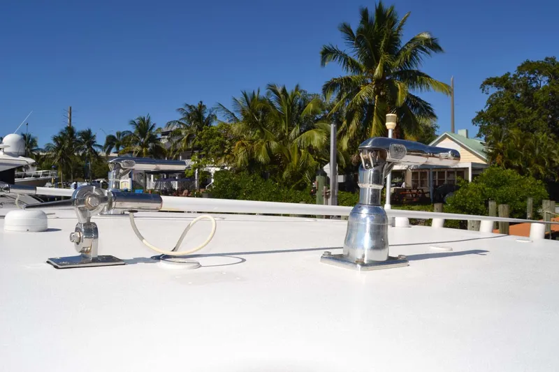 Slide: The Image of 2012 Jupiter 34 FS boat deck with fishing rod holders, palm trees in background. - 17