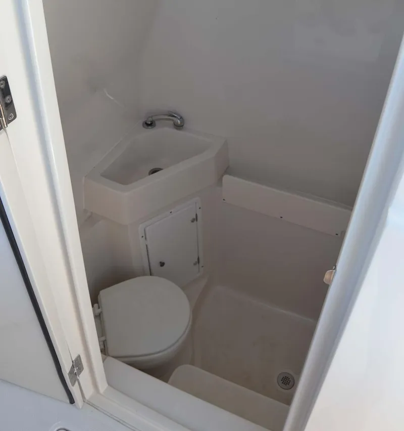 Slide: The Image of Compact bathroom in 2012 Jupiter 34 FS boat with sink and toilet. - 18