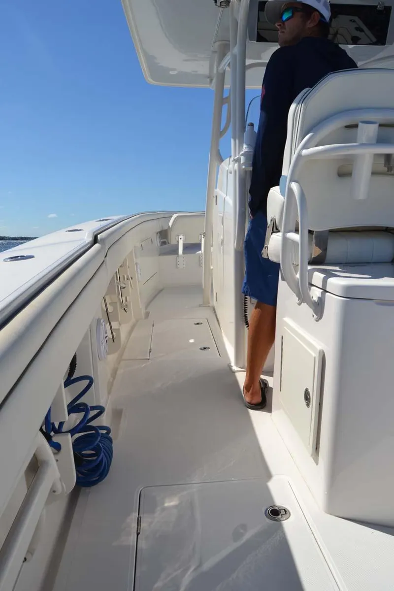 Slide: The Image of 2012 Jupiter 34 FS boat deck with person standing, clear blue sky. - 26