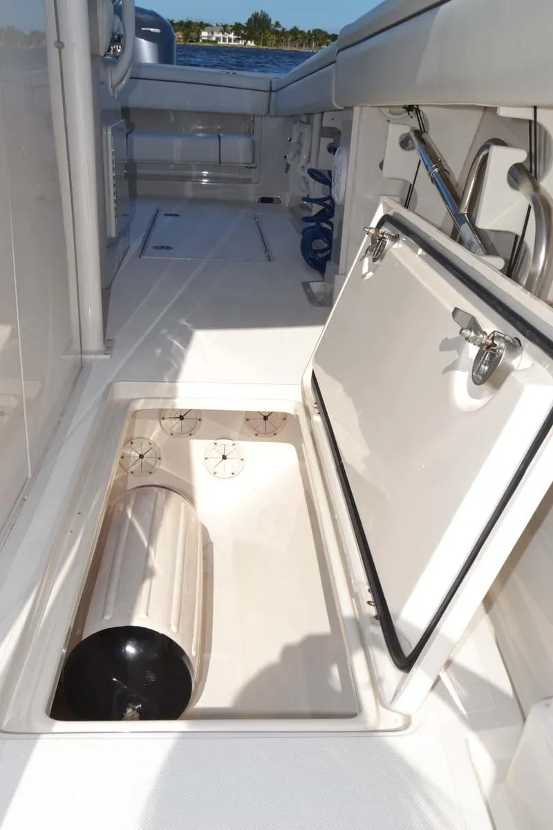 Slide: The Image of 2012 Jupiter 34 FS boat storage compartment with open hatch and cylinder. - 28