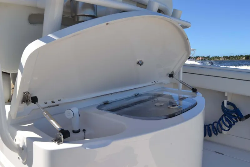 Slide: The Image of Open storage compartment on 2012 Jupiter 34 FS boat, with clear blue sky background. - 29