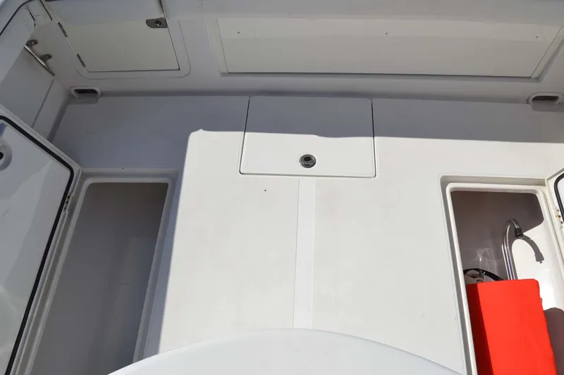 Slide: The Image of 2012 Jupiter 34 FS boat deck with storage compartments and red safety equipment. - 33