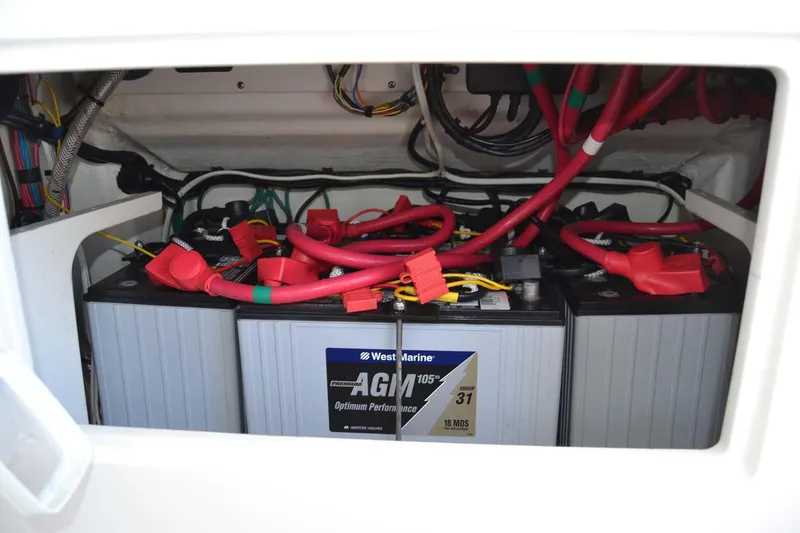 Slide: The Image of AGM batteries with red cables in a 2012 Jupiter 34 FS boat. - 35