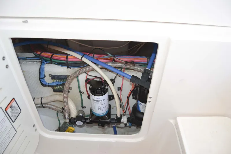 Slide: The Image of 2012 Jupiter 34 FS boat wiring and plumbing system inside compartment. - 37