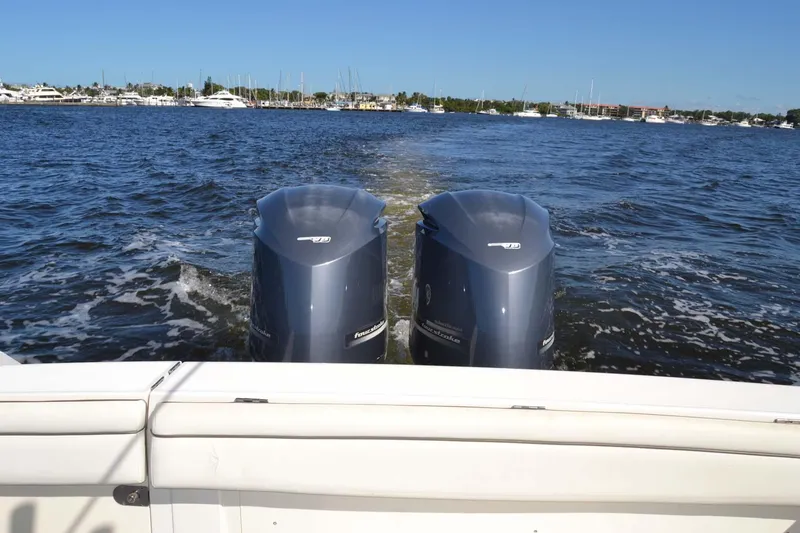 Slide: The Image of 2012 Jupiter 34 FS boat with dual outboard motors on open water. - 41