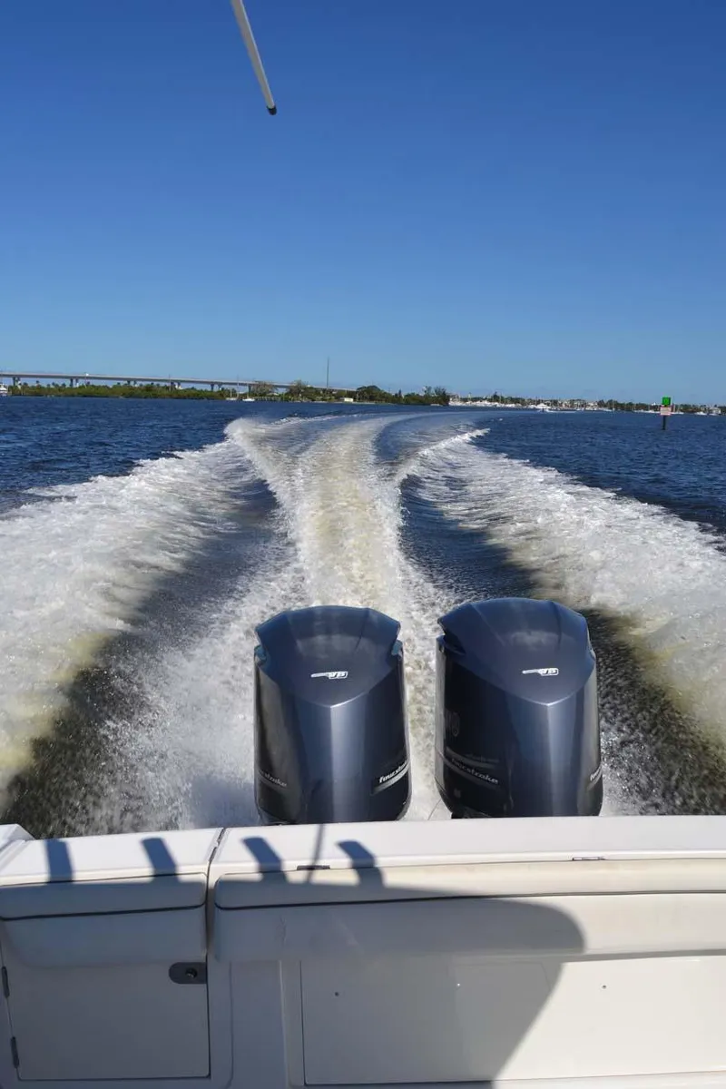 Slide: The Image of 2012 Jupiter 34 FS boat with dual engines cruising on open water. - 43