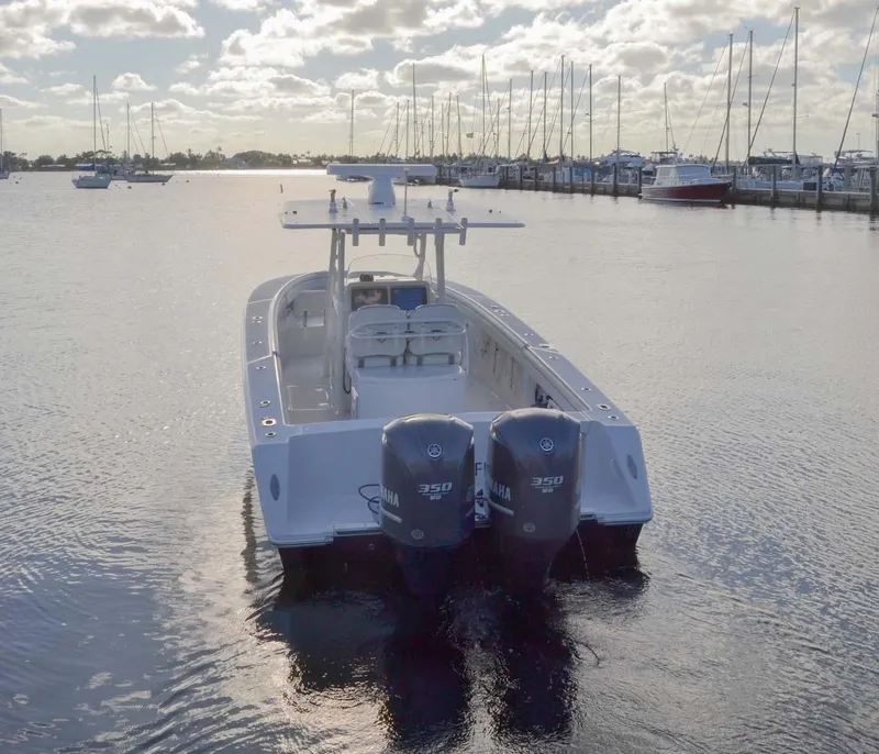 Slide: The Image of 2012 Jupiter 34 FS boat with twin engines on calm water at marina. - 45