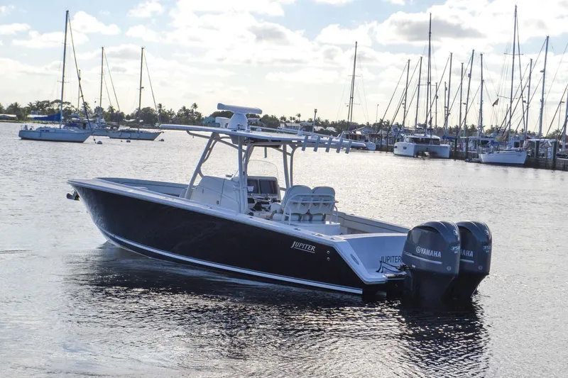 Slide: The Image of 2012 Jupiter 34 FS boat docked in marina with Yamaha engines. - 46