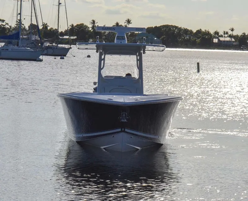 Slide: The Image of 2012 Jupiter 34 FS boat on calm water, with sailboats in the background. - 47