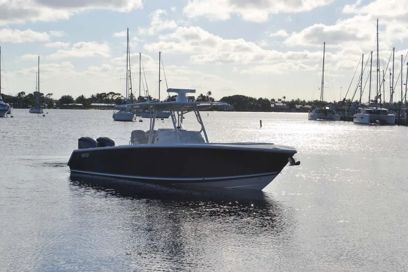 Slide: The Image of 2012 Jupiter 34 FS boat on calm water with sailboats in the background. - 48