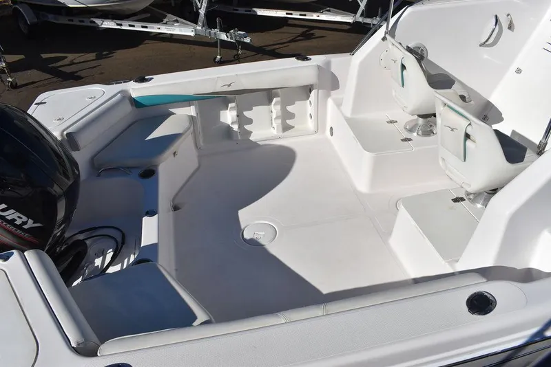 Slide: The Image of 2016 Pro-Line 20 Express boat interior with seating and motor. - 12