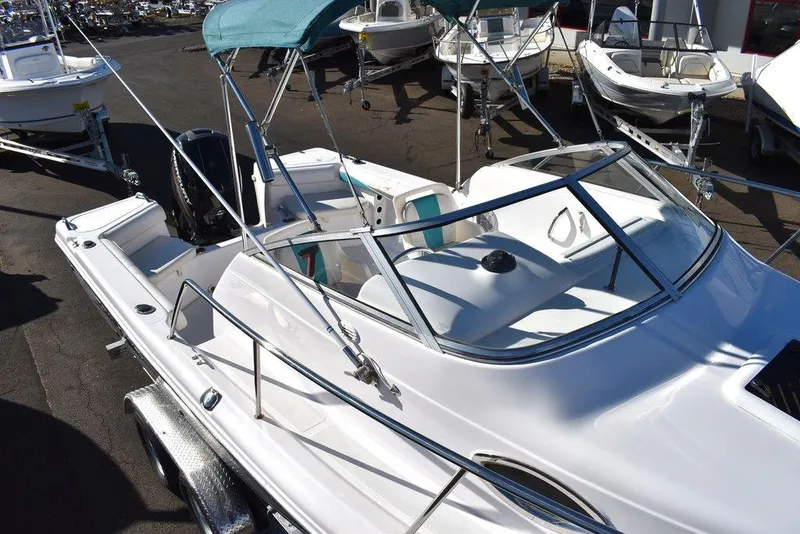 Slide: The Image of 2016 Pro-Line 20 Express boat with canopy, docked among other boats. - 15