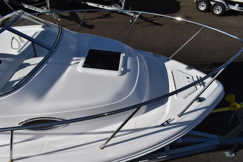 Slide: The Image of 2016 Pro-Line 20 Express boat, white deck, sleek design, stainless steel railings. - 16