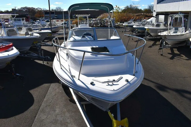 Slide: The Image of 2016 Pro-Line 20 Express boat displayed in a marina, front view. - 19
