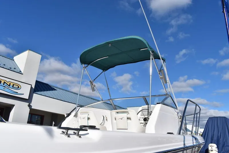 Slide: The Image of 2016 Pro-Line 20 Express boat with canopy under clear blue sky. - 20