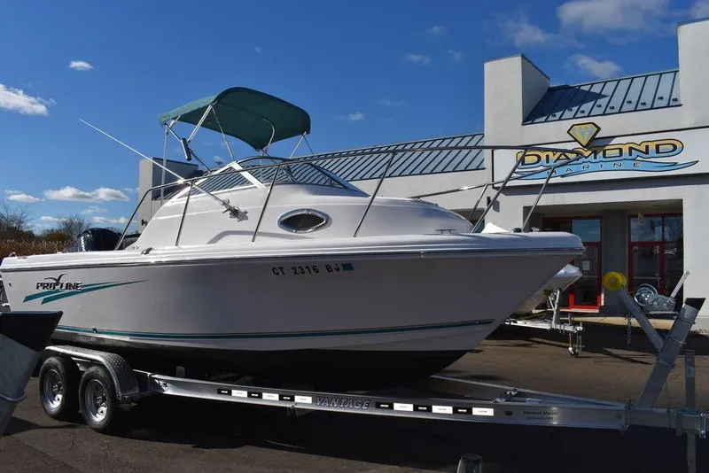 Slide: The Image of 2016 Pro-Line 20 Express boat on trailer outside dealership. - 23