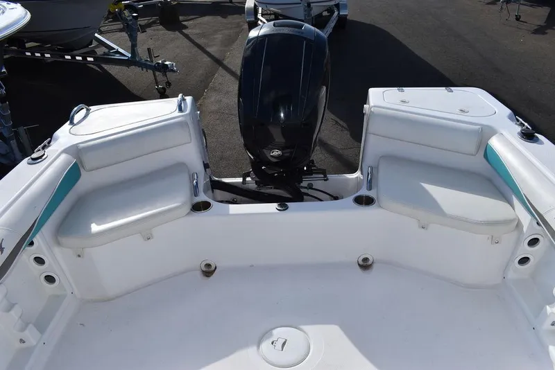 Slide: The Image of 2016 Pro-Line 20 Express boat interior with seating and motor view. - 25