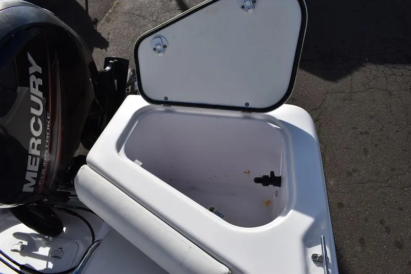 Slide: The Image of Open storage compartment on 2016 Pro-Line 20 Express boat with Mercury engine. - 27