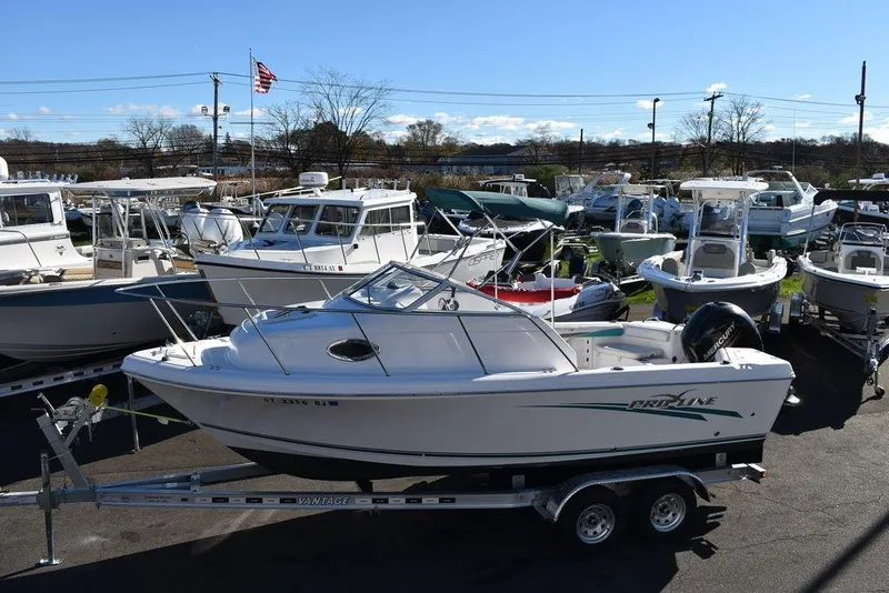 Slide: The Image of 2016 Pro-Line 20 Express boat on trailer in marina setting. - 3