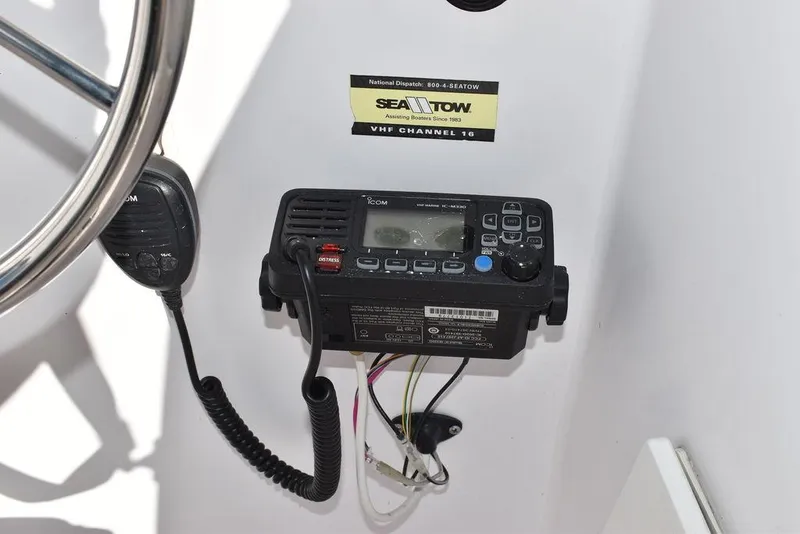 Slide: The Image of VHF radio and microphone on 2016 Pro-Line 20 Express boat dashboard. - 46