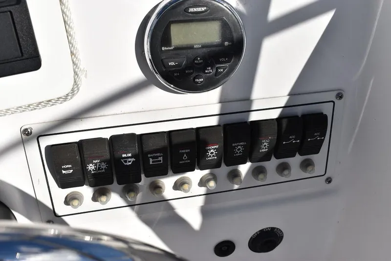 Slide: The Image of Control panel of 2016 Pro-Line 20 Express boat with switches and Jensen stereo. - 47