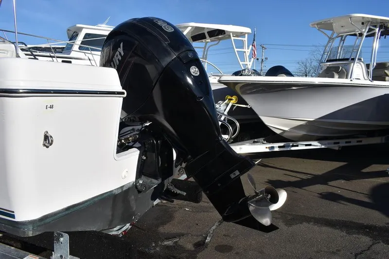 Slide: The Image of 2016 Pro-Line 20 Express boat with outboard motor in a marina setting. - 9