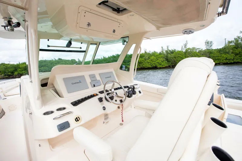 Slide: The Image of Interior of 2016 Grady-White 376 Canyon boat, featuring modern helm and seating. - 17
