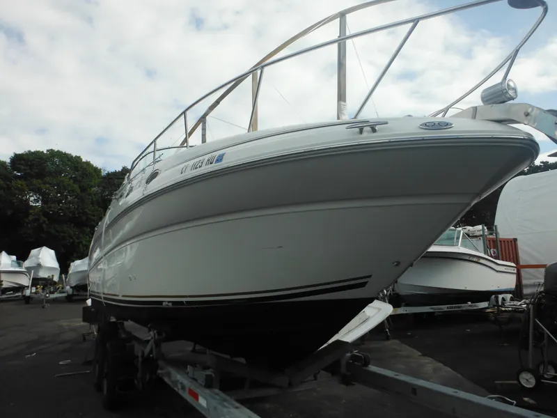 Slide: The Image of 2002 Sea Ray 260 Sundancer boat on trailer, parked outdoors. - 11