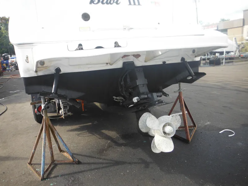 Slide: The Image of 2002 Sea Ray 260 Sundancer boat on stands, showing propeller and stern details. - 13