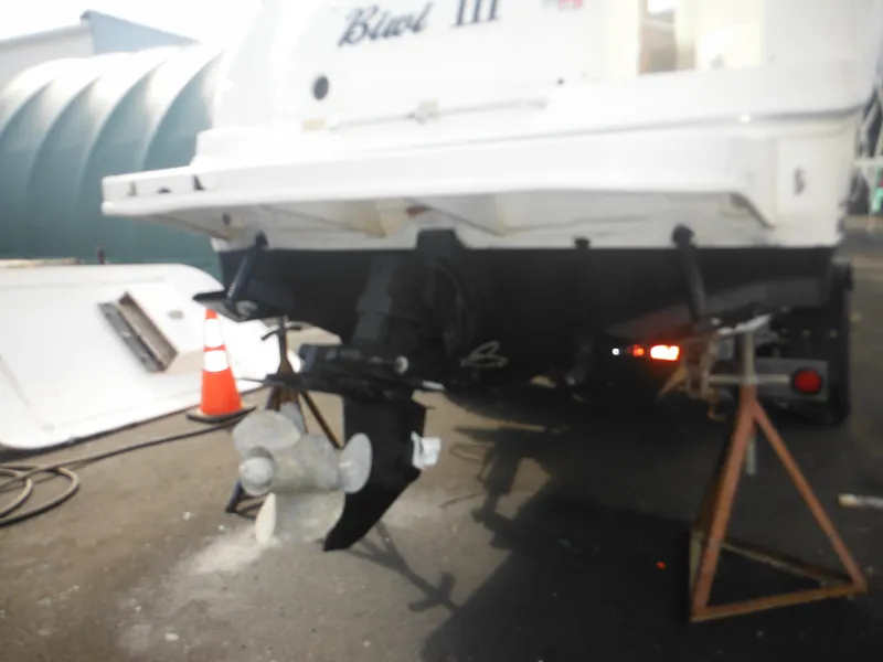 Slide: The Image of Rear view of a 2002 Sea Ray 260 Sundancer boat on stands. - 14