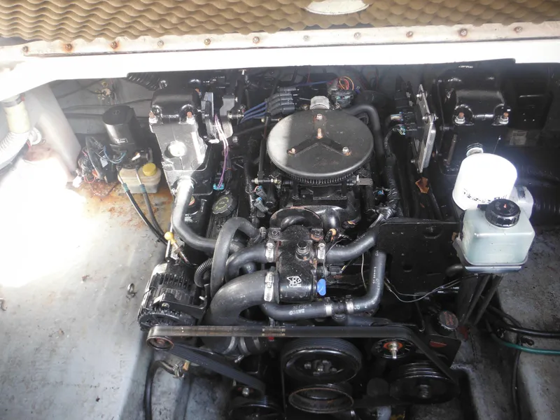 Slide: The Image of Engine compartment of 2002 Sea Ray 260 Sundancer boat, showcasing mechanical components. - 20