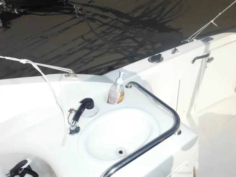 Slide: The Image of Sea Ray 260 Sundancer 2002 boat sink with soap dispenser on deck. - 25
