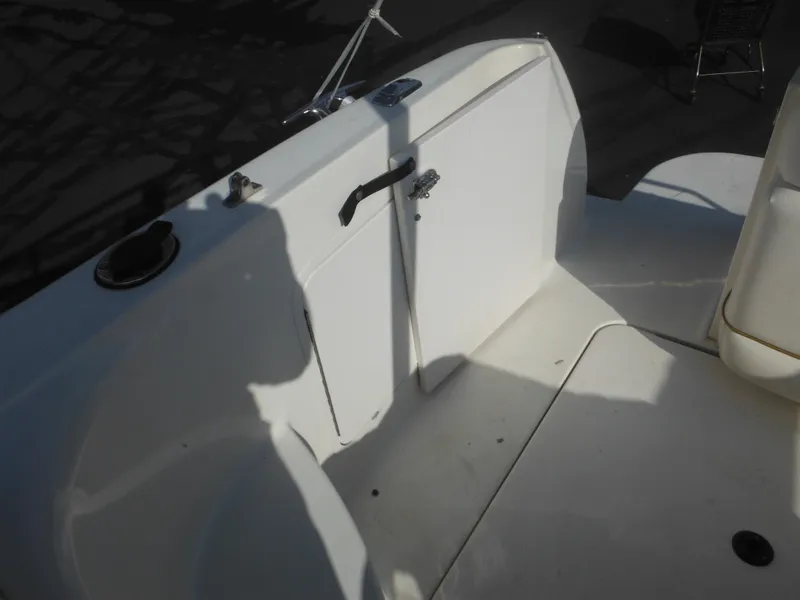 Slide: The Image of 2002 Sea Ray 260 Sundancer boat deck with storage compartment and handle. - 26