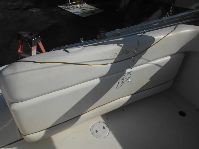 Slide: The Image of 2002 Sea Ray 260 Sundancer boat interior seating with logo detail. - 27
