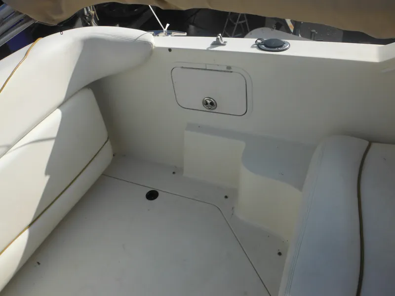 Slide: The Image of Interior seating of 2002 Sea Ray 260 Sundancer boat, featuring white upholstery. - 28