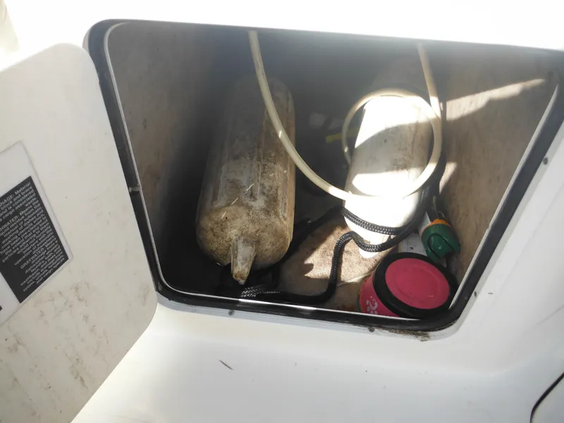 Slide: The Image of Storage compartment of 2002 Sea Ray 260 Sundancer boat with equipment and supplies. - 31