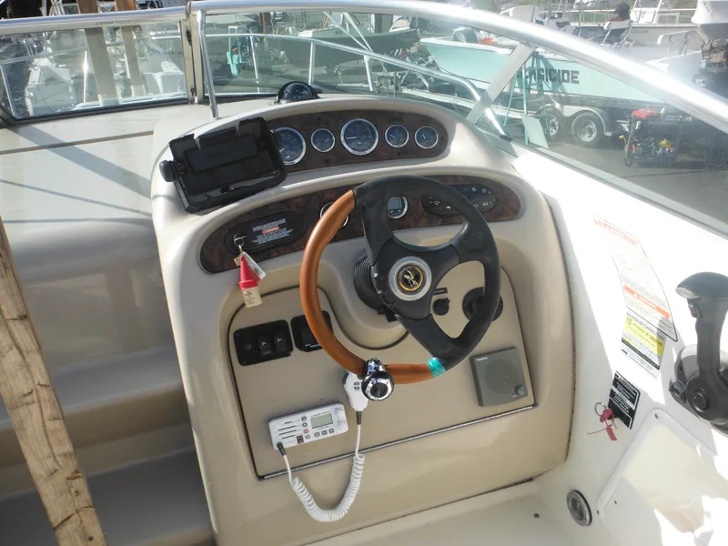 Slide: The Image of 2002 Sea Ray 260 Sundancer helm with steering wheel and instrument panel. - 32