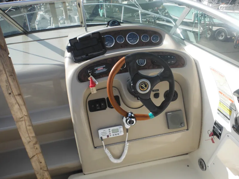 Slide: The Image of 2002 Sea Ray 260 Sundancer helm with steering wheel and instrument panel. - 35