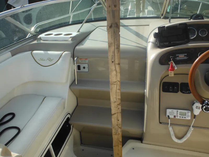Slide: The Image of Interior view of 2002 Sea Ray 260 Sundancer boat cockpit with steering wheel. - 36