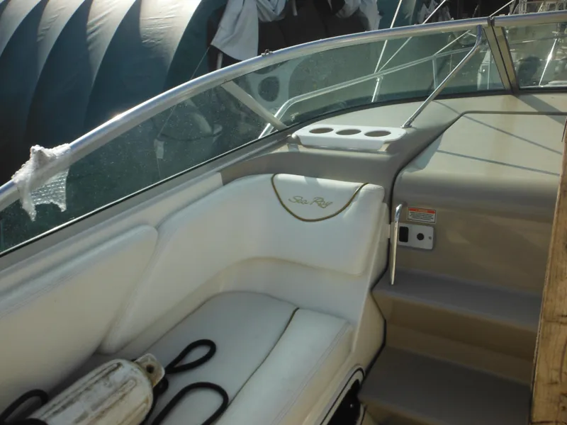 Slide: The Image of 2002 Sea Ray 260 Sundancer boat interior with seating and cup holders. - 37