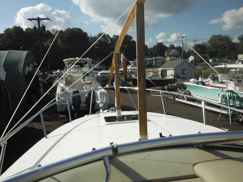 Slide: The Image of 2002 Sea Ray 260 Sundancer in a busy marina, surrounded by other boats. - 39