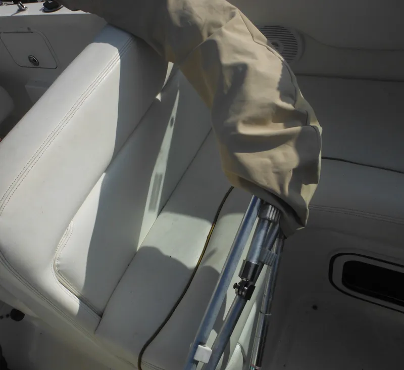 Slide: The Image of Interior of 2002 Sea Ray 260 Sundancer boat with white seating and covered railing. - 41