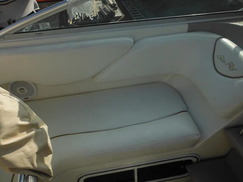 Slide: The Image of Interior seating of 2002 Sea Ray 260 Sundancer boat, featuring white upholstery. - 42